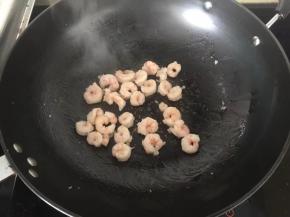 5、虾仁也放入炒锅小火炒出多余水分。