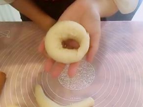 然后下端围过来，将扇形面皮贴合好围过来的下端面条，形成一个圆圈，收口始终保持向下。