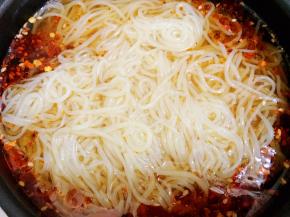 取出冷面汤，把沥干水的面条放入