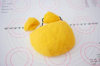 取出面团先分三分之一出来，再把这三分之一的面团对半切，做小熊的耳朵，剩下三分之二做小熊的脸，然后盖上保鲜膜醒发15分钟