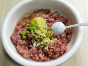 将切好的葱姜蒜末加入肉糜中，加入盐。