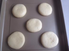 将小面团用手掌压一下，再用擀面棍擀一擀，不用擀太薄，要有点厚度，放在烤盘上