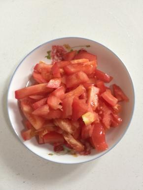 西红柿洗净去蒂，切成小块儿备用。