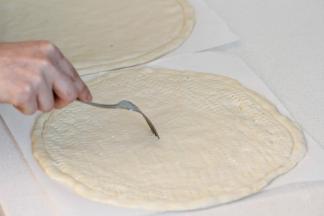 面团移到油纸上整理好，用叉子扎些孔。