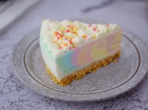 淡奶油加入糖粉打发裱花状态，再从冰箱取出慕期蛋糕，再用吹风机对着模具四周吹一吹，用手从底部轻轻往上托即可脱模成功，底部用锯齿刀划过即可脱模，然后在上面挤出自己喜欢的花纹，再撒上彩色糖珠做装饰即可