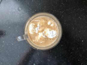 打好的咖啡奶昔倒入杯中，把剩余的棉花糖用勺子挖成小球放入杯中。