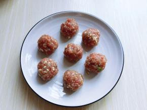 将腌制好呢肉糜搓成肉丸，放入盘中。