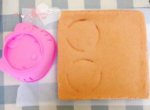 晾凉的蛋糕片比着模具切出两个合适大小的蛋糕片。