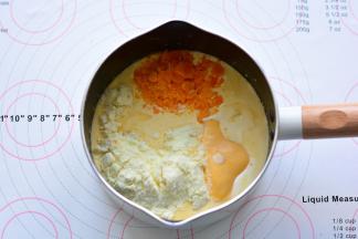 搅拌均匀后放入奶粉、细砂糖、芝士片、蒸熟的咸蛋黄，用手动打蛋器搅拌均匀，