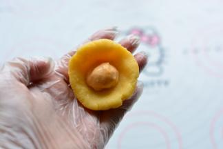 取奶黄馅捏成面皮状，包入冷冻好的流心馅，流心馅需要冷冻到足够硬，包的时候最好在冰箱里面包，防止融化，如果拿出来包，一个一个的拿，包完一个再拿另一个