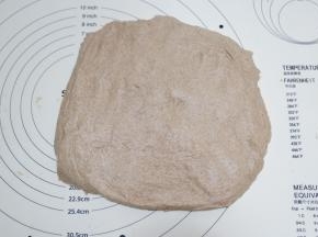 发酵好的面团倒扣出来，按压排气