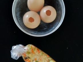 把刚才炒好的馅装到保鲜袋，绑紧袋口。