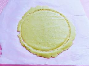 将模具取下，成为一个大圆饼，再用牙签在饼皮上扎出小孔，边角不需要取下来，如图。