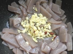 把魔芋拨到两边，放入蒜瓣，生姜，花椒，干辣椒爆香。