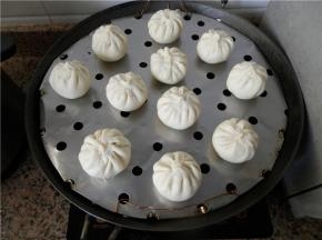 逐个包好，锅里放冷水，包子生胚排好在抹了油的蒸架上，生胚中间留些空隙，盖上锅盖，静置饧发（冬天：锅里放温水）。