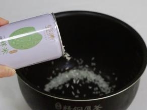 打开一罐（206克）稻花香米，倒入电饭锅内。