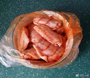 带上一次性手套给鸡翅反复按摩、抓匀后腌制4小时以上，放冰箱过夜更佳
