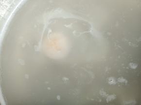 关火，将鸡蛋打入锅中，待鸡蛋凝固变白后开火，中小火煮至荷包蛋熟透，捞出放入碗中