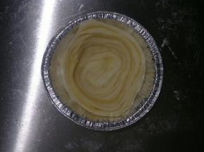 取一个面团，横切面朝上，放入挞托中