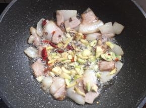 放入生姜，蒜瓣，花椒，干辣椒爆香。