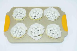 16、预热烤箱190度，挞皮上放油纸和重石。