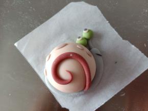 29.粘到小蜗的壳上，再用紫色面团做点缀
