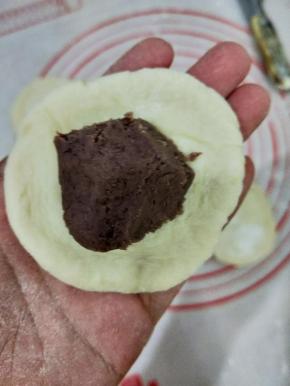 然后放入适量绿豆馅，捏好。