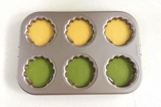 冷藏完毕后取出，把面糊倒入玛德琳模具中，八分满。