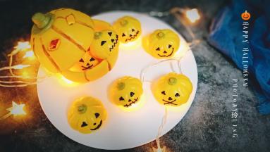 16.晾凉后，把巧克力放裱花袋隔热水融化，在南瓜馒头上画出表情，可可粉加一点点水混合，用毛刷将大南瓜的纹路刷一下，顺便用刀子抠两个洞洞作为表情