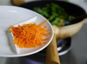 微微炒至青菜米粉出味之后，再将胡萝卜及少许的细盐鸡精料酒下锅。