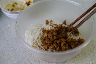 然后将炒好的肉末酱汁一并加至在米粉里面。