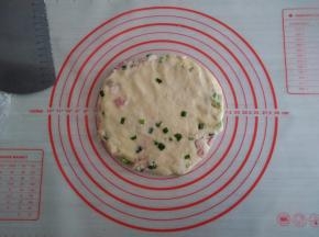 将面团移至案板上，压成圆形，不要压得太薄