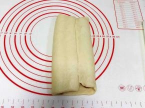 剩下右边的白色面片往左边折过来，捏紧收口。