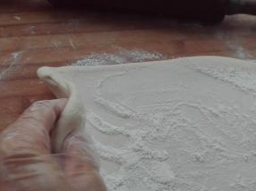 擀好后，继续撒干面粉，均匀抹在面片上