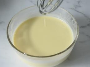 把牛奶混合液缓缓倒入蛋黄糊里，一边倒一边搅拌。