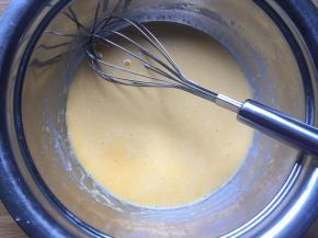 将搅拌好的玉米油和纯牛奶倒入蛋黄糊中，搅拌均匀