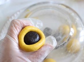 放入馅料，类似于包汤圆的方式，用手虎口位置推到收口。