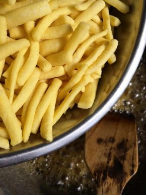 放入炸好的面条，翻炒使每个面条都裹上糖浆