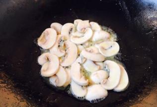 放入蘑菇片，煸炒均匀。