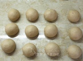 面团挤压排气后，均分成12个小面团，滚圆松弛15分钟。