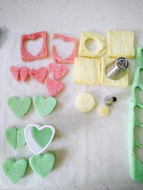 纸杯蛋糕用锯齿刀分层，粉色用小一圈的心形刻模，原色戚风用裱花嘴刻出大小圆形备用（小象帽子），用剩余的边角料剪出小象鼻子。。