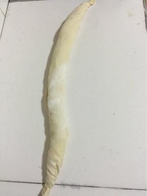 从一头慢慢的卷起来！把卷好的面团两边捏紧，把面团旋转拧成麻花一样！
