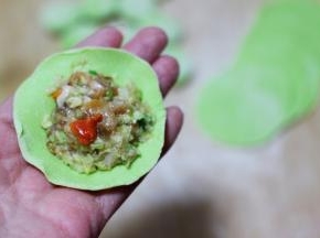 擀好的面皮上放入适量调好的馅料。
