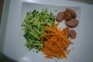 把黄瓜、胡萝卜洗净擦丝，火腿丁切片