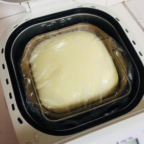 揉好的面团取出来，整形揉圆放在面包桶中，盖上保鲜膜，按面包机发酵键，发酵至两倍大！