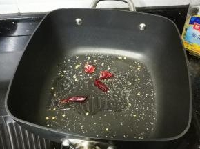 不粘锅放入油、糖、盐、干辣椒爆香