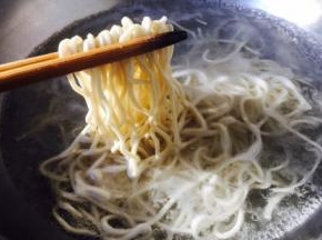 捞出面条盛在碗中，然后再面上浇上肉末香菇酱，吃的时候拌一拌。