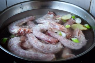 鸡脖焯水。 鸡脖焯水要用凉水，水中放适量的姜片和葱段。