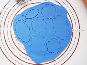 .取一块翻糖膏加入色素调出自己想要的颜色，擀成薄片，用同样的模具刻出来。