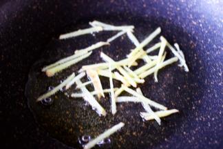 锅烧热后倒入花生油烧至六成热时，加入姜丝爆香，这样也是为了下步煎鲫鱼的时候，鱼不会煎碎呀。